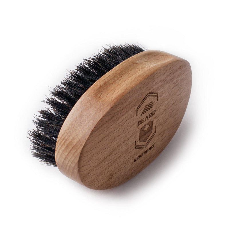Beard Reverence 100% Boar bristle. Features a handle made of wood with a company logo.  